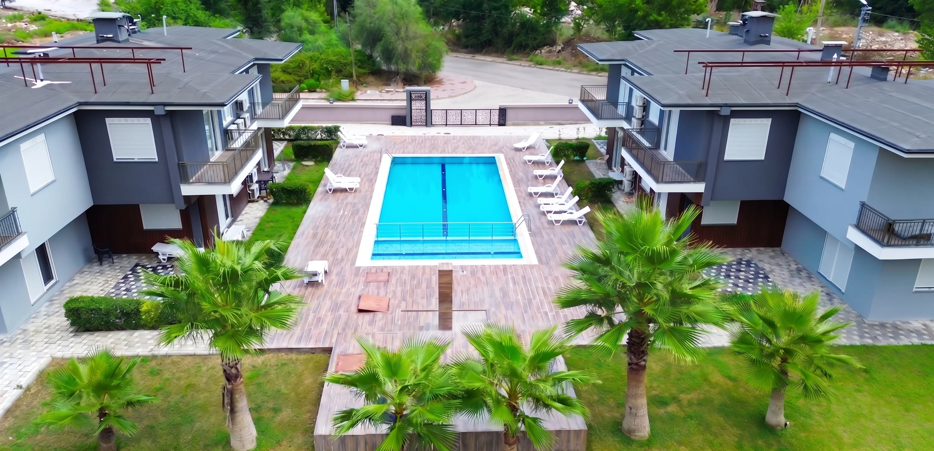 Aerial drone view of Palmiye Home property with pool in Göynük Kemer